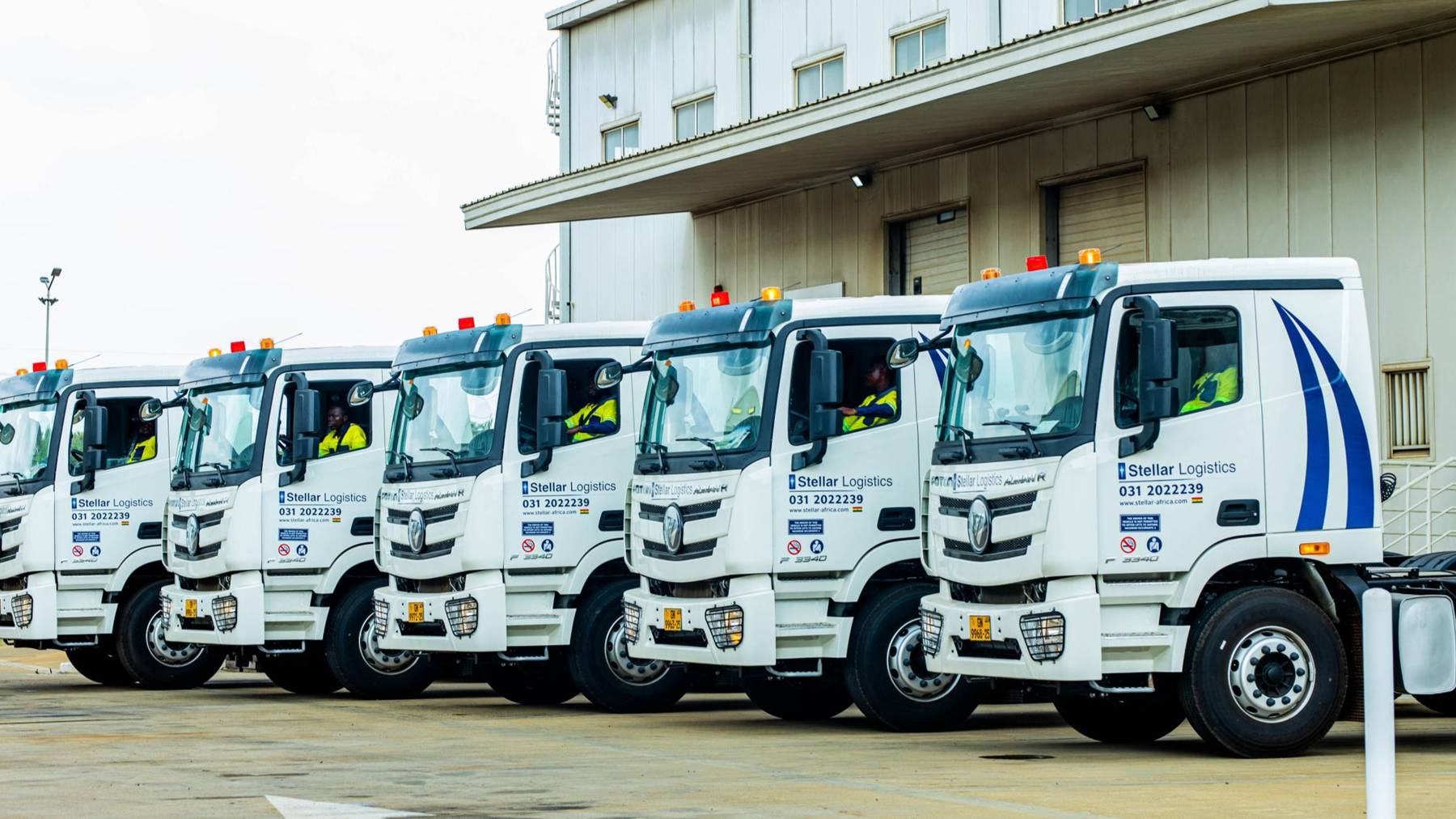 Stellar Logistics tractor-trailers lined up outside a warehouse